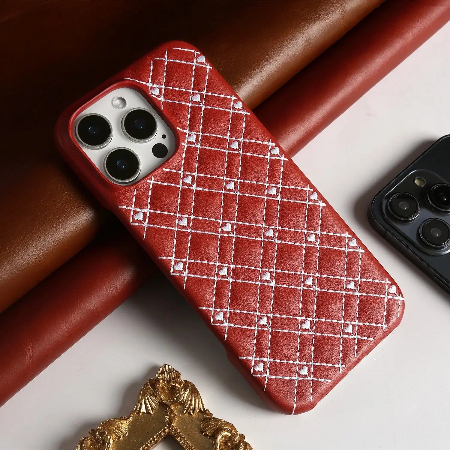 Genuine leather iPhone case features a delicate heart embroidery stitching